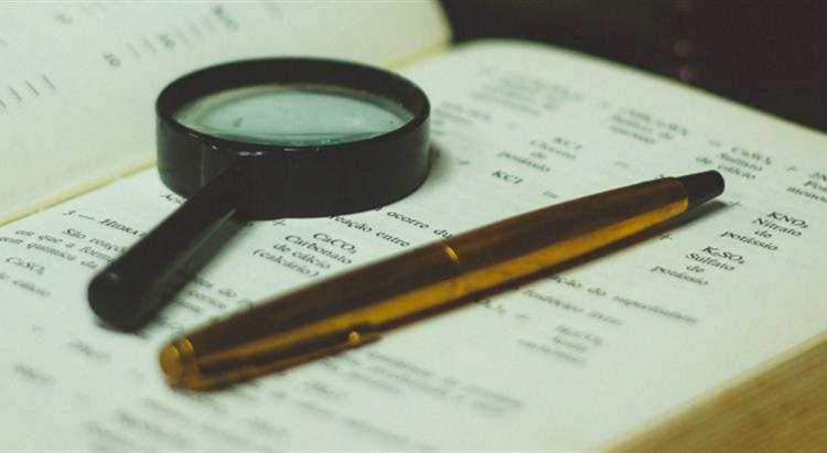 Magnifying glass on book